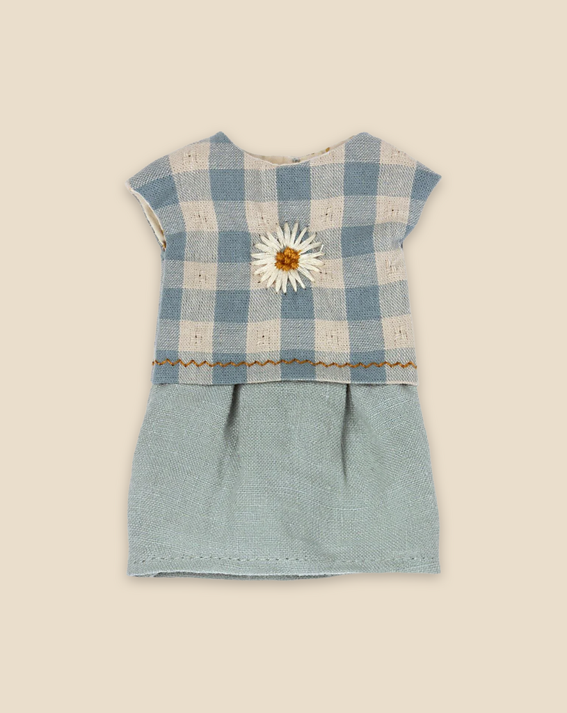 The Maileg Teddy Bedroom Set (ships in one week) features a small dress with a blue and white checkered top, fabric daisy, and light blue skirt—perfect for Maileg Teddy Mum, shown on a beige background.