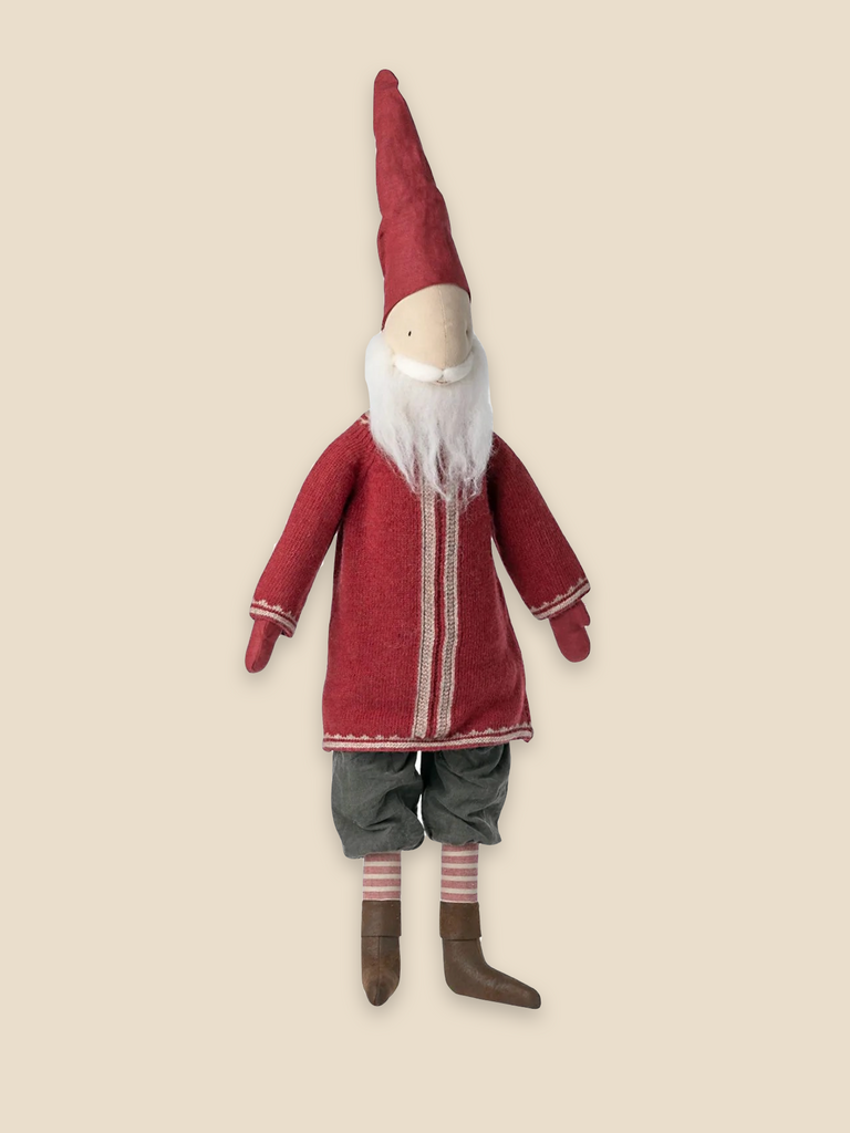 A Maileg Small Santa (Size: 33.46 in.) toy with a long white beard, wearing a red Santa hat and coat with white trim, green shorts, and striped socks against a beige background.