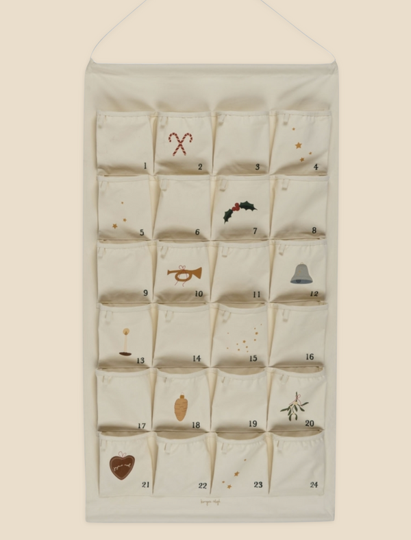 A Noel Christmas Calendar with 24 numbered pockets, each decorated with holiday prints like stars, stockings, and a Christmas tree.