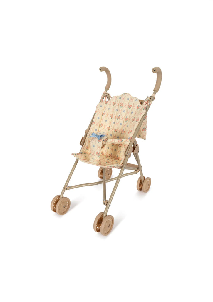 The Konges Sloejd Doll Stroller - Fleur Decor is a delightful beige and brown stroller with a removable floral-patterned fabric seat. It features four sets of double wheels and curved handles, making it ideal for imaginative play or as a charming decorative piece.