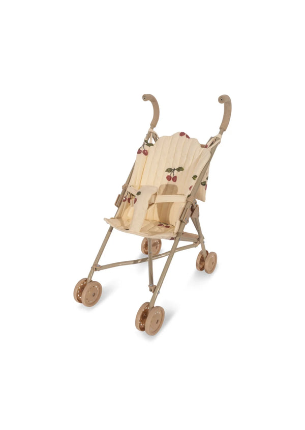 The Konges Sloejd Doll Stroller in Grande Cherry Pink Glitter is a beige umbrella stroller with a charming cherry print design on the removable fabric. It features curved handles and four double wheels, all set against a crisp white background, reminiscent of a chic doll stroller.