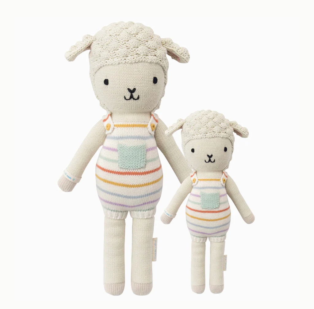 Two Cuddle + Kind Lamb Stuffed Animals, one larger and one smaller, standing upright. Both toys feature striped clothing and smiling faces, isolated on a white background.