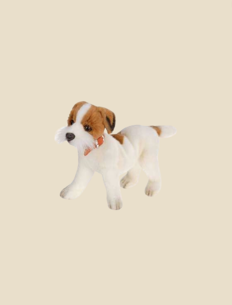 A hand-sewn plush toy of a Jack Russel Terrier dog with a white and tan coat and a red collar, set against a plain light beige background.