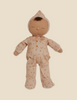 A Dozy Dinkum - Bugsy Hopscotch plush toy from the Olli Ella x Odin Parker collection, in the shape of a baby, wearing a peach onesie with a floral pattern and a hood, displayed against a light beige background.