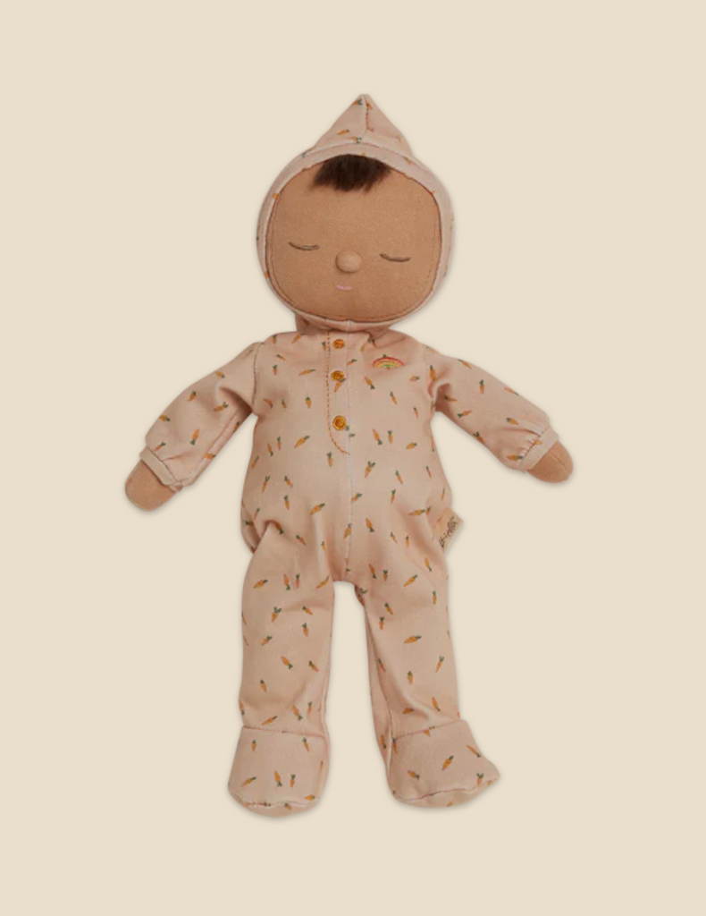 A Dozy Dinkum - Bugsy Hopscotch plush toy from the Olli Ella x Odin Parker collection, in the shape of a baby, wearing a peach onesie with a floral pattern and a hood, displayed against a light beige background.