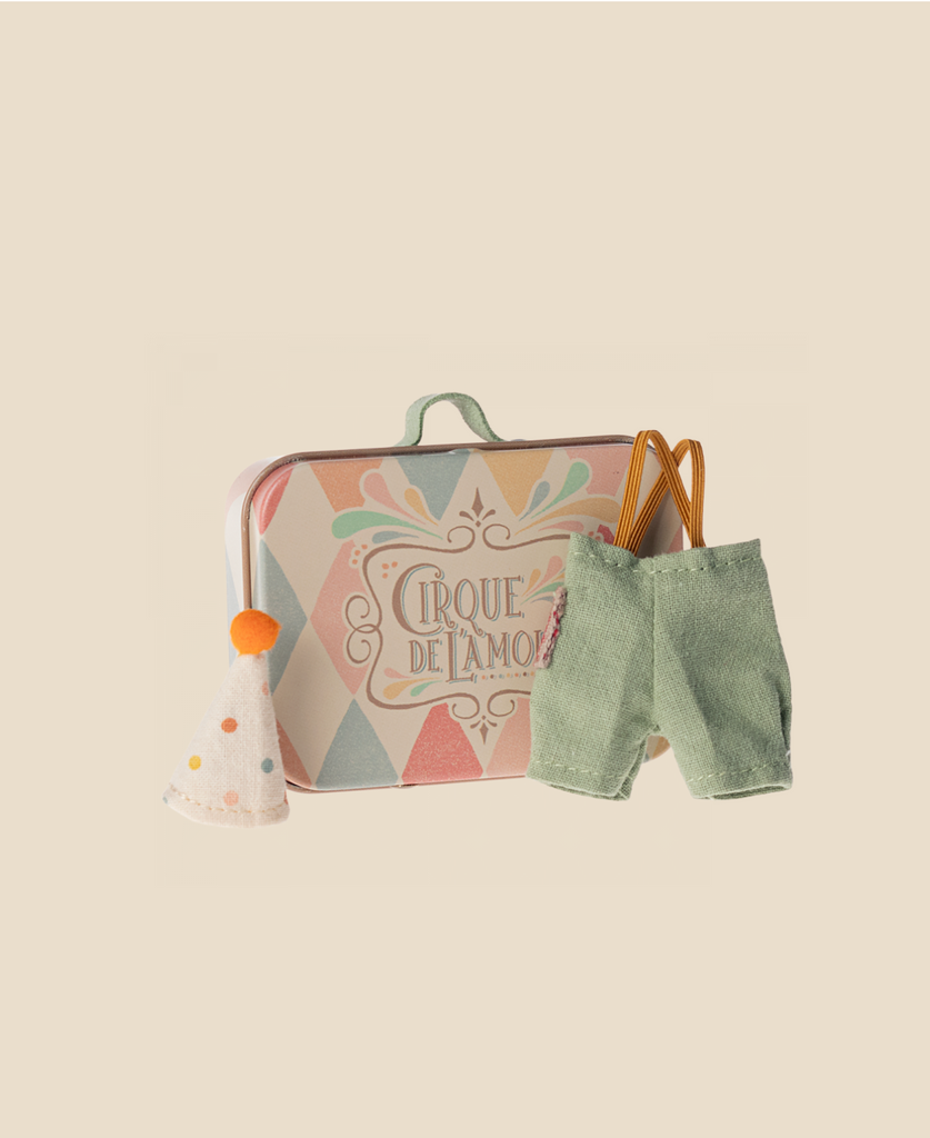 A small pastel suitcase with "Cirque de l'amour," a white party hat, green overalls, and brown suspenders—charming accessories included in the Maileg Family Theater Set for your Maileg mice.