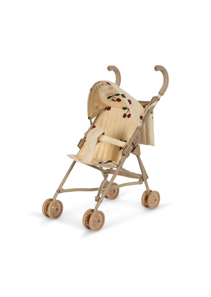 A Konges Sloejd Zoe Doll Stroller - Cherry with four pairs of double wheels and curved handlebars. It features a foldable shade adorned with cherry motifs and a quilted seat with safety straps. The stroller has a minimalist and classic design.