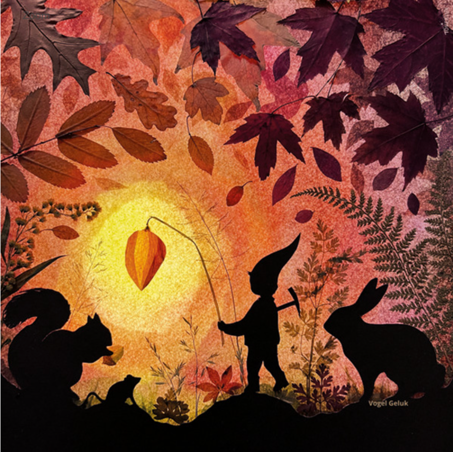 An autumn-themed illustration for the Silhouette Only - Little Lantern Silhouette for Toverlux Lamp features a small gnome-like figure holding a leaf on a string, surrounded by the magical silhouettes of a squirrel, mouse, rabbit, and various leaves and plants against a warm, glowing background. The artist's name, "Vogel Geluk," is clearly visible on the artwork. Ships in approximately one week.