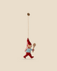 Introducing the Maileg Metal Ornament, Pixy Spoon: a delightful festive decoration showcasing a small elf adorned in a red hat and pants, blue shirt, and striped scarf, delicately holding a wooden spoon. Crafted in the charming style of Maileg ornaments, it effortlessly hangs from a thin beige string against a light beige background.