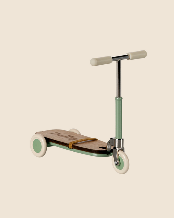 The Maileg Mouse Size Scooter / Kickboard - Mint features a sleek, modern design with a mint green handlebar and front wheel, beige grips, elegant wooden deck details, white wheels, and a minimalist look. Ships in approximately one week.