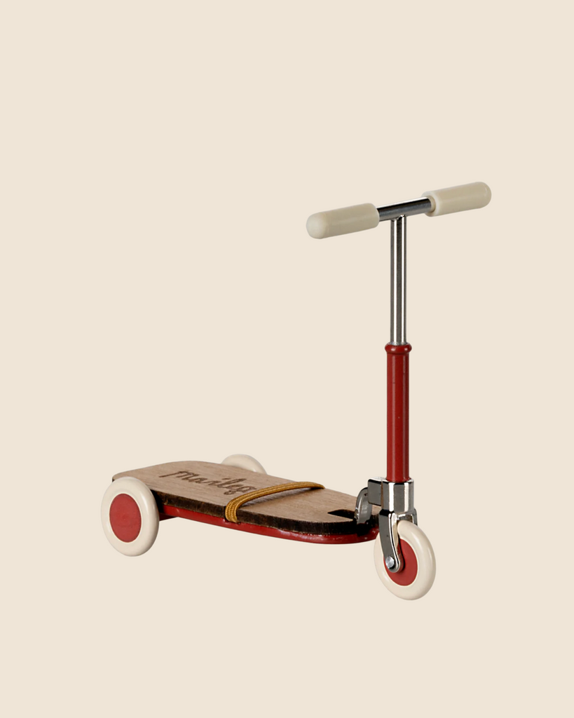 The Maileg Mouse Size Scooter / Kickboard - Red features vintage-style cream and red wheels, wooden deck accents, and cream handlebars on a metallic frame, all set against a light beige background. (Ships in approximately one week.).