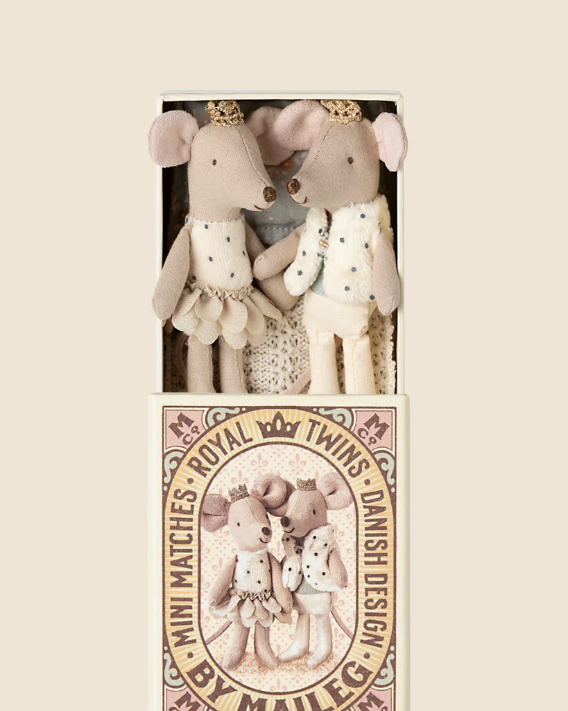 A pair of plush royal twin mice, the Little Sister as a princess and the Little Brother as a prince, are nestled in a decorated matchbox labeled "Mini Matchies." This delightful Maileg set, available for pre-order and shipping late February, adds a touch of regal charm.