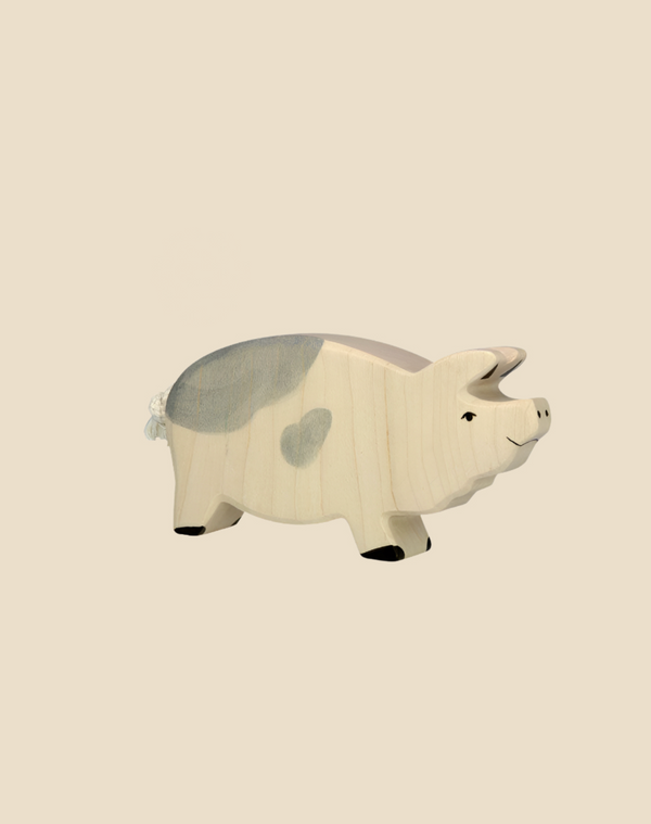 The Holtztiger Boar, a handcrafted wood toy with light gray spots and a small tail, stands on a plain beige background. Ships in one week.