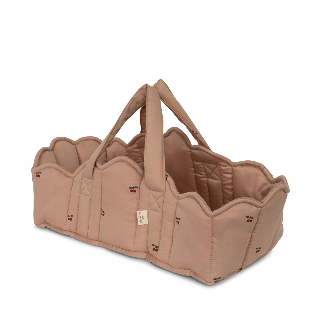 The Konges Sloejd Doll Lift - Cherry Blush is a quilted soft pink basket with scalloped edges, embroidered cherries, and two sturdy straps, crafted to OEKO-TEX® STANDARD 100 for safe carrying or storing of items.