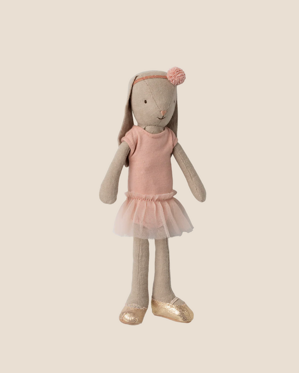 The Maileg Bunny, Size 2 - Classic, wears a rose ballet suit and skirt, and gold shoes. It stands upright against a plain beige background.