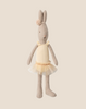 The Maileg Rabbit, Size 1 - Classic, wears a cream ballet suit and skirt, accented with a flower headband. Standing upright on a beige background, it looks like a little ballet dancer.