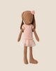 A Maileg Bunny, Size 1, in chocolate brown, wears a rose ballet suit and skirt. This adorable doll resembles a tiny ballerina and stands out beautifully against a plain beige background.