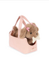 The Konges Sloejd Maude Puppy in Basket features a soft puppy toy with pink bows and a white bone, nestled inside a pink-and-white checkered handled dog basket.