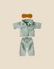 Maileg Extra Clothing: Pyjamas For Dad Mouse includes a light blue striped shirt, matching pants, and a brown eye mask for dad mouse, displayed on a beige background.