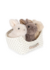 The Konges Sloejd Bunnys in Basket Set includes a fabric basket with black polka dots, a front label, and four plush toy bunnies in cream, beige, brown, and gray resting on a cozy padded bed.