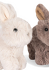 The Konges Sloejd Bunnys in Basket Set features two plush bunnies—one cream, one light brown—with soft fur, upright ears, and black eyes. Perfect as nursery décor or a cuddly accent on a padded bed.