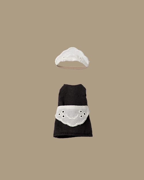 The Maileg Extra Clothing: Maid Clothes for Big Sister Mouse features a petite black dress with apron and matching white bonnet, both laid flat on a beige background—classic maid attire in miniature for your mouse.