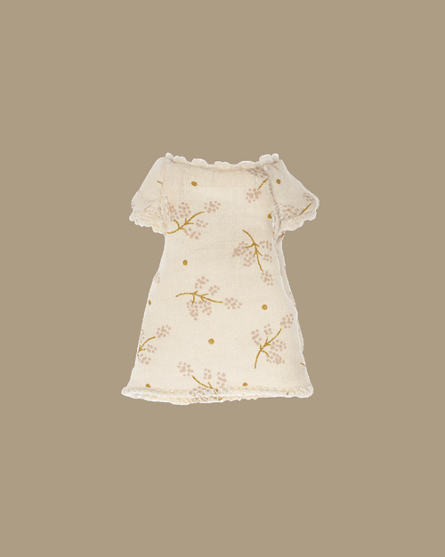 The Maileg Extra Clothing: Nightgown For Little Sister Mouse is a small, cream nightgown with short sleeves, a floral branch pattern with yellow dots, and a scalloped edge—perfect for your little mouse's next pyjama party.