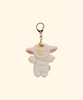 The Olli Ella Cozy Bag Charm - Lamby Pookie is a plush keychain featuring a small doll with closed eyes in a fluffy white lamb costume, big ears, and a gold keyring. Set against a light beige background, it's perfect as a Cozy Dinkum accessory.