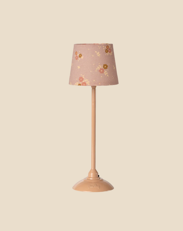 Pre-order the Maileg Floor Lamp, Miniature - Dark Powder (arrives by 03/15/26), featuring a pink base and a floral-patterned shade with yellow and red flowers—an ideal, charming accessory for any dollhouse. Set against a beige background.