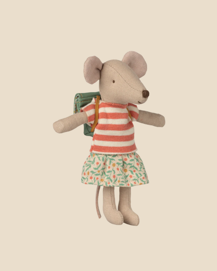 Pre-order the Maileg Tricycle Mouse, Big Sister – Green, featuring a small mouse doll in a red and white striped shirt, floral skirt, and green backpack. Expected arrival by 05/01/26. Set against a plain light beige background.