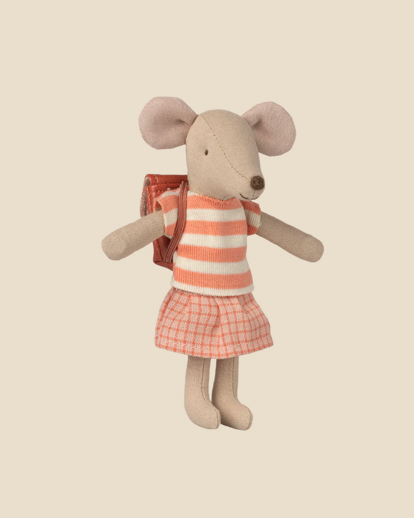 The Pre-order: Maileg Tricycle Mouse, Big Sister - Coral (arriving by 05/01/26) wears a pink and cream striped top, pink plaid skirt, and red school backpack, posed against a plain beige background.