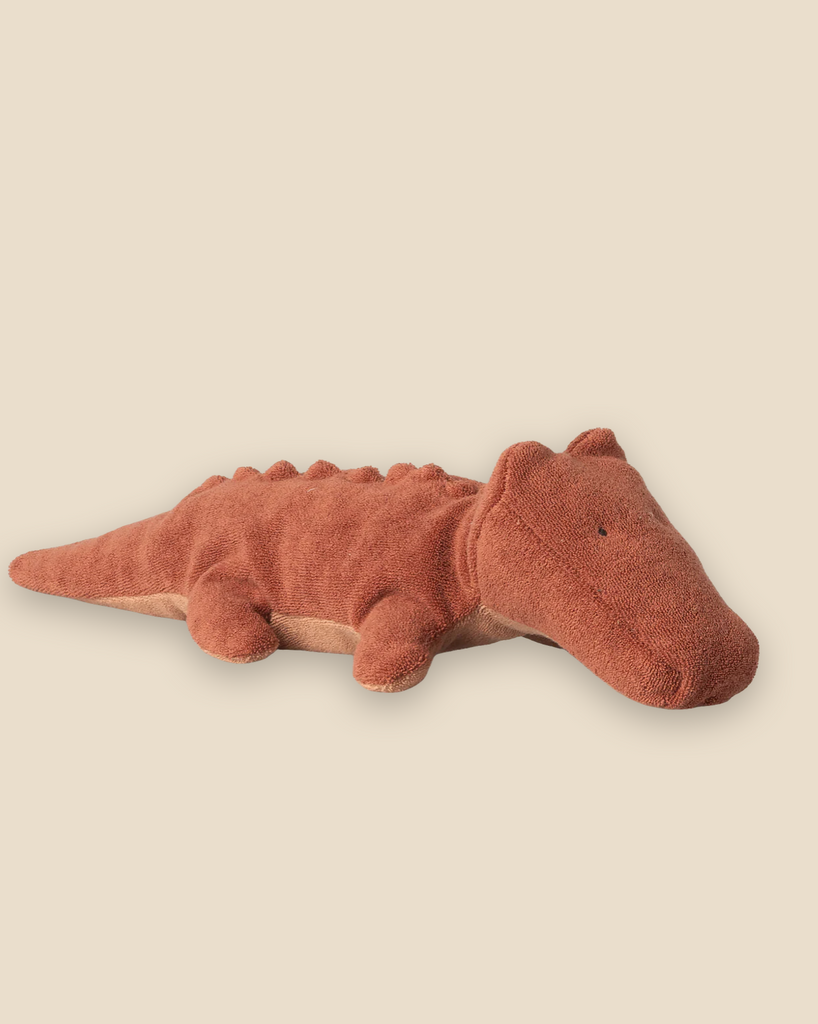 The Pre-order: Maileg Crocodile, Small - Vintage Rose is a soft, reddish-brown plush toy with a rounded snout and stitched details, perfect for crocodile fans. Expected arrival by 06/15/26. Displayed on a pale beige background.