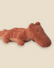 The Pre-order: Maileg Crocodile, Medium - Vintage Rose is a plush toy with soft, textured fabric, simple stitched eyes, and a rounded snout. Shown lying on a light beige background. Expected arrival by 06/15/26.