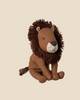 Pre-order: Maileg Little Leo the Lion—a small plush toy with a fluffy mane, button eyes, and a stitched nose—sits on a light beige background. Expected arrival by 06/15/26.