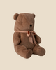 The Pre-order: Maileg Teddy Bear Plush, Medium - Soft Brown (arriving by 06/15/26) sits upright with a pink ribbon bow, ready to be your most huggable companion against a plain beige background.