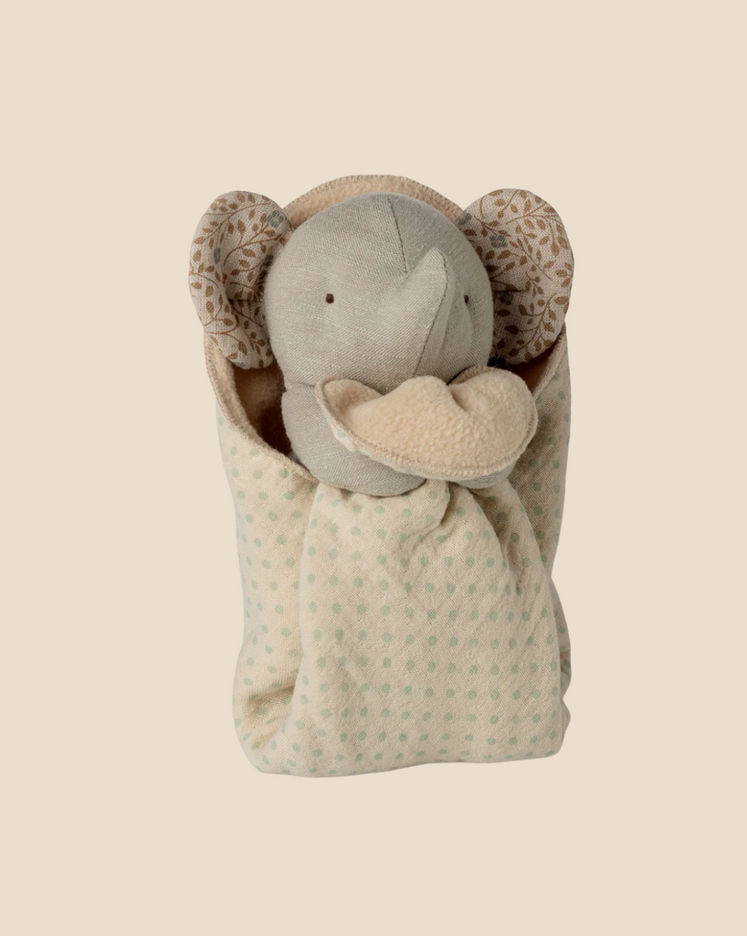 The Pre-order: Maileg Lullaby Friends, Elephant, Mini - Iron Grey (arriving 04/15/26) is a soft plush toy with patterned ears, partially wrapped in a cream pouch with light green polka dots—a charming newborn gift.