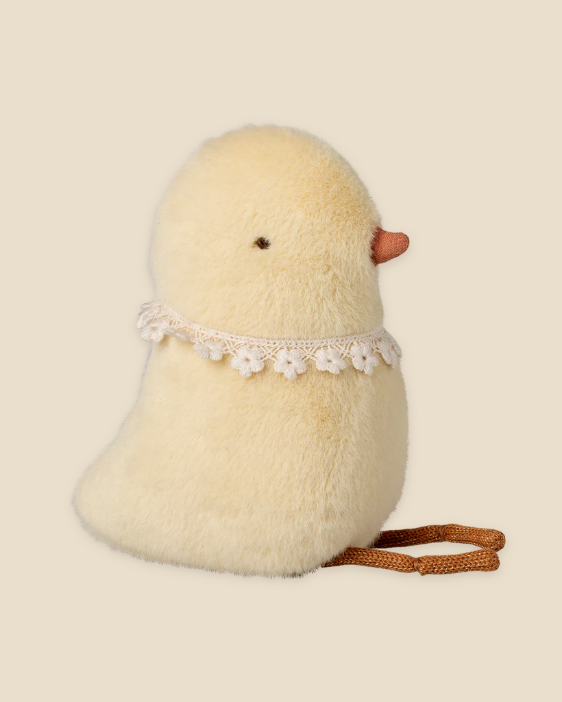 The Pre-order: Maileg Chicken Plush, Small—featuring a soft yellow body, orange beak, black eyes, lace flower collar, and brown legs—sits against a beige background. Expected arrival by 03/01/26.