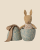 The Pre-order: Maileg Easter Egg with Micro Rabbit, Small - Dusty Blue features a soft rabbit in a polka-dot dress inside a blue, floral-patterned metal egg—an adorable gift for children. Expected arrival by 02/15/26.