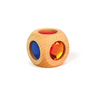 The Bauspiel Magic Cube (Single) is a wooden toy cube with round holes on each side, each holding a blue, red, or orange transparent gem. Ideal for educational construction sets. Displayed against a white background.