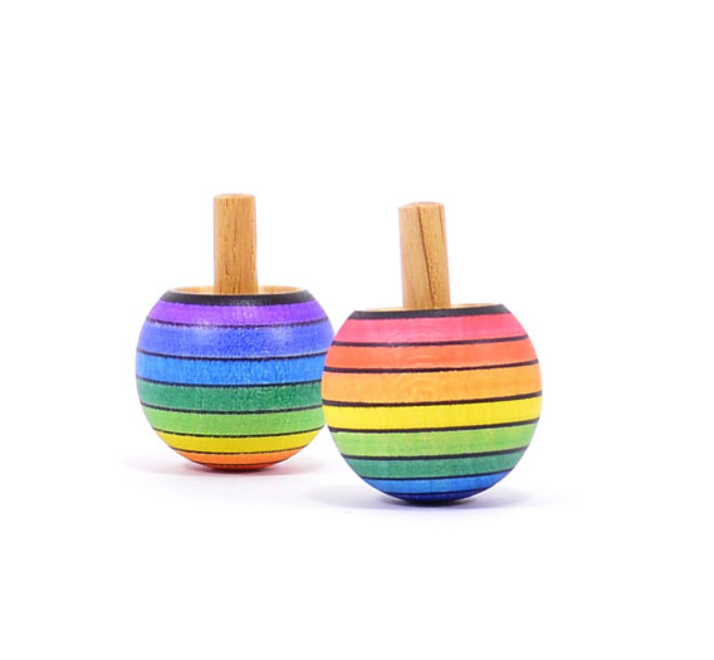 Two Mader Rainbow Turn-Over Spinning Tops in red, featuring rainbow gradient stripes and short handles, are standing upright on a white background.
