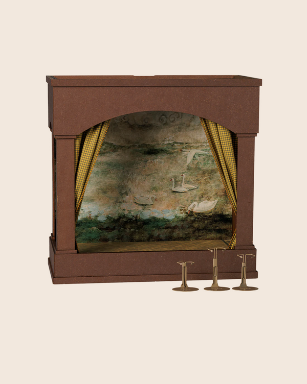 The PRE-ORDER: Maileg Theater With Light, Mouse Size (arriving mid-November) includes yellow gingham curtains, a swan pond backdrop, three mini candlestick stands, and a reversible background for changing scenes.