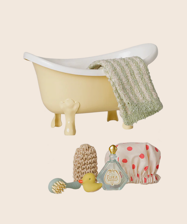 The PRE-ORDER: Maileg Bathtub Set, Mouse - Yellow (arriving mid-October) includes a yellow clawfoot tub, green knitted towel, kids bath accessories, polka-dot shower cap, bath brush, loofah, rubber duck & vintage perfume bottle—perfect for pretend play.