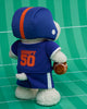 Peanuts Snoopy - American Football plush features Snoopy as a football player in a blue helmet and "Snoopy 50" jersey, holding a football on a green field—an adorable Peanuts plush from Bon Ton Toys.