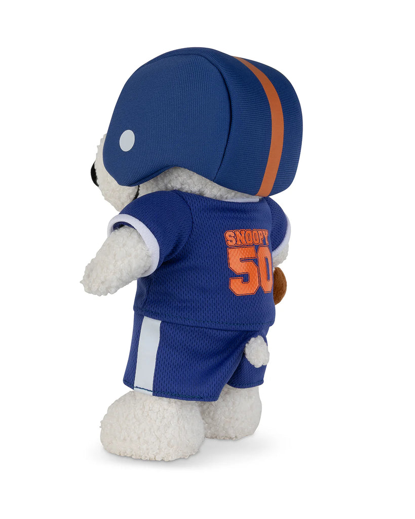 The Peanuts Snoopy - American Football plush by Bon Ton Toys features Snoopy in a blue football helmet and matching jersey with the number 50 and "Snoopy" in orange on the back, posed against a white background.