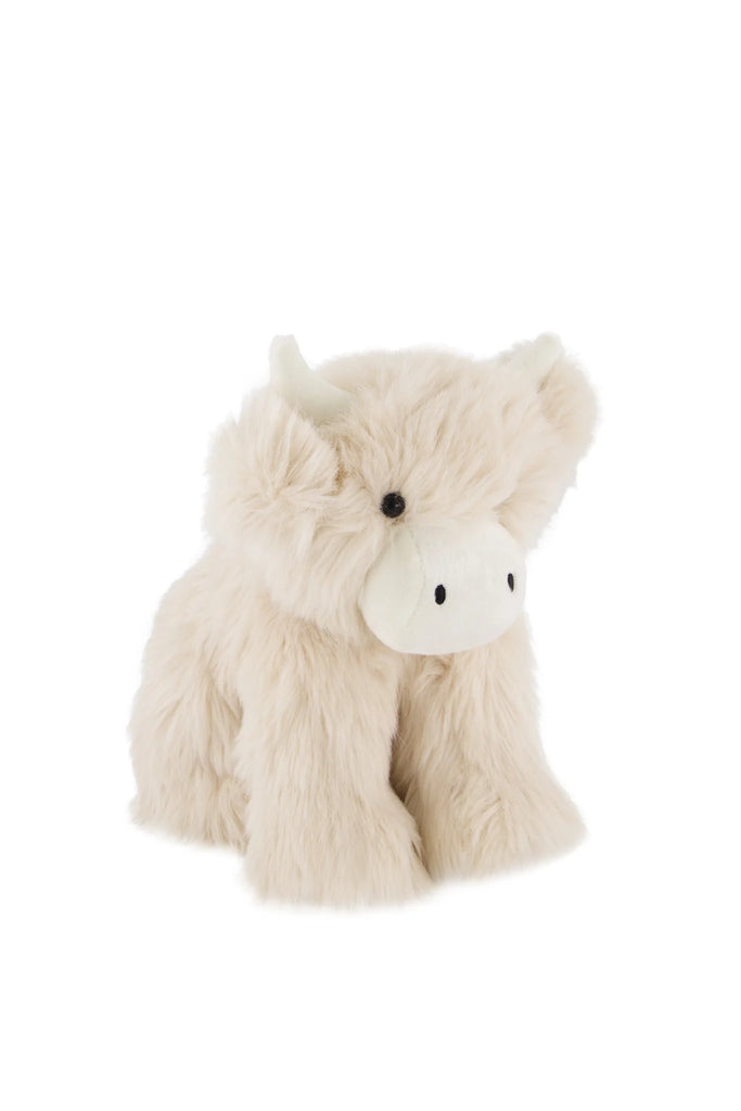 Snuggle Bunnies - Hilda The Highland Cow features soft cream-colored fur, small white horns, and black button eyes—an adorable plush sitting upright on a plain white background, perfect for cuddling or as a baby shower gift.