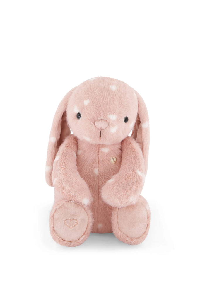 Snuggle Bunnies - Penelope - Little Love is a blush pink bunny soft toy with white spots, long floppy ears, black button eyes, and a small embroidered heart on one paw. Sitting facing forward against a white background, it makes the perfect keepsake gift.