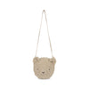 A Teddy Bear Shoulder Bag with a smiling face, hanging by a single beige adjustable shoulder strap against a white background.