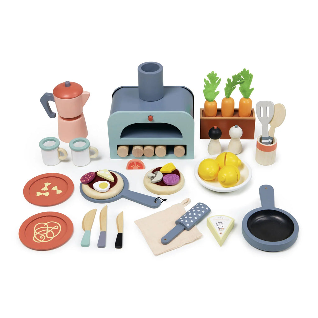 The La Fiamma Grand Kitchen, a wooden play kitchen set, comes with play food including a pizza oven toy, utensils, coffee pot, plates, pizza, pasta, vegetables, lemons, and a frying pan—all arranged neatly on a white background.