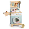 Introducing the Wooden Laundrette: a delightful wooden toy set that includes a washing machine, mini iron, detergent bottle, cleaning supplies, sink, hanging towels, and a small basket with an extra towel. Featuring pastel colors and playful details, the Wooden Laundrette is perfect for inspiring imaginative pretend play and fun laundry adventures.