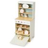 The Kitchen Dresser and Dishwasher is a wooden children's play kitchen set featuring shelves that display toy dishes, cups, plates, and a teapot in soft pastel colors. At the bottom, a pull-down door opens to reveal additional toy kitchen accessories—just like a miniature toy dishwasher.